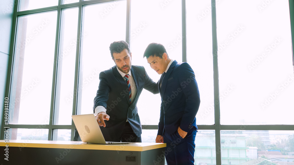 Two business people talk project strategy at office meeting room. Businessman discuss project planni