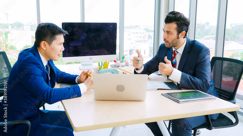 Two business people talk project strategy at office meeting room. Businessman discuss project planni