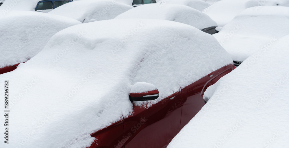 Snow covered parked cars. Winter season	