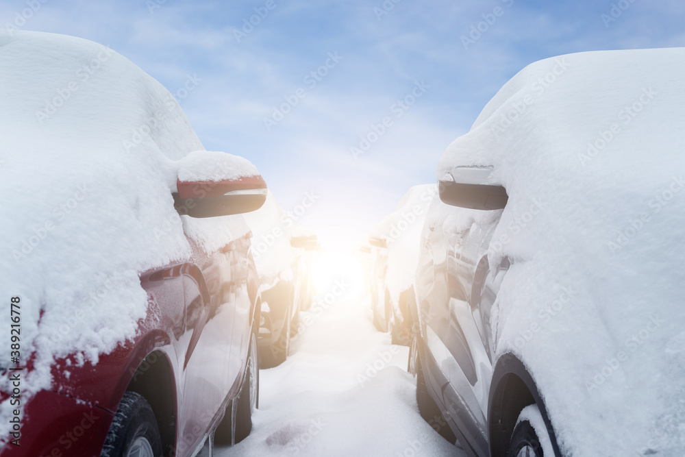 Snow covered parked cars. Winter season	