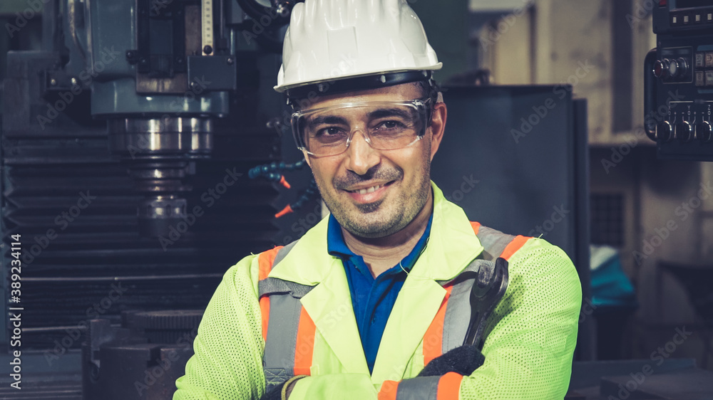 Young factory worker or engineer close up portrait in factory . Industry and engineering concept .