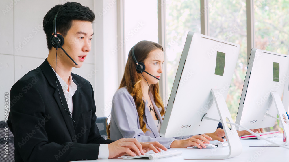 Business people wearing headset working in office to support remote customer or colleague. Call cent