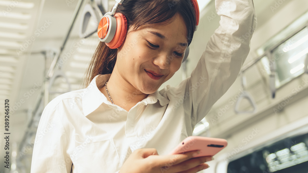 Young woman mobile phone on public train . Urban city lifestyle commuting concept .