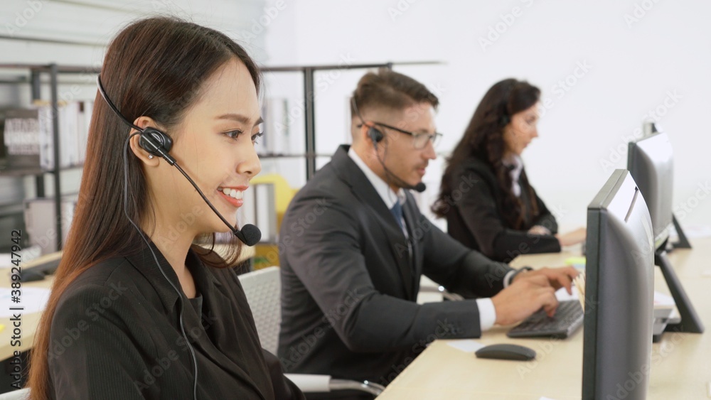 Business people wearing headset working in office to support remote customer or colleague. Call cent