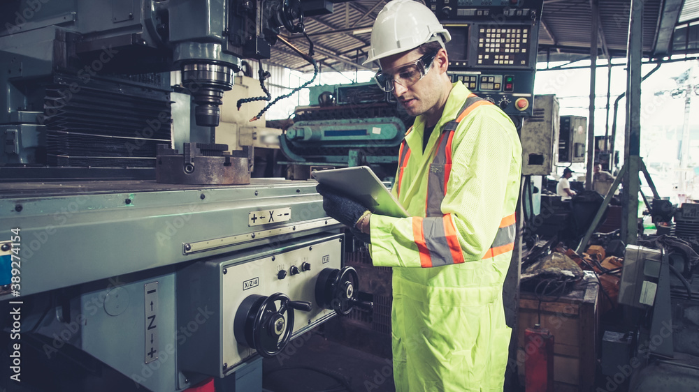 Smart factory worker using machine in factory workshop . Industry and engineering concept.