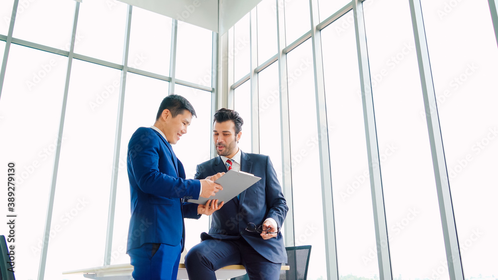 Two business people talk project strategy at office meeting room. Businessman discuss project planni