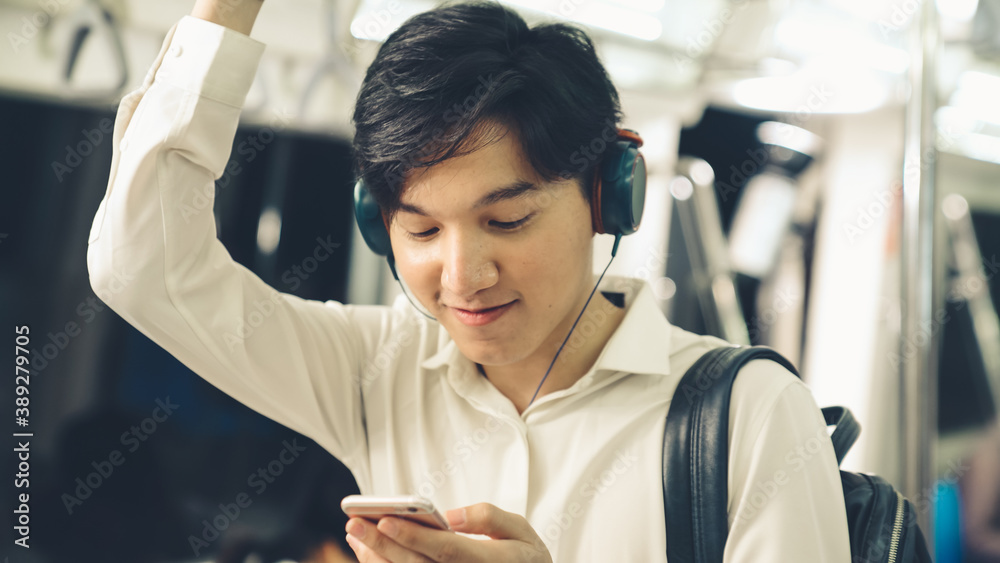 Businessman using mobile phone on public train . Urban city lifestyle commuting concept .