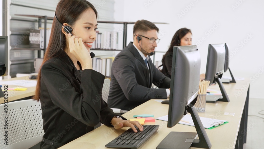 Business people wearing headset working in office to support remote customer or colleague. Call cent