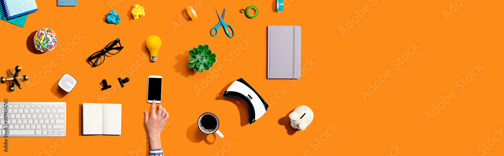 Collection of electronic gadgets and office supplies - flat lay