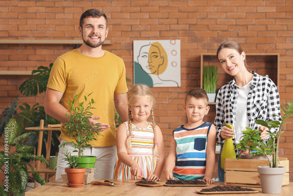 Young family setting out plants at home