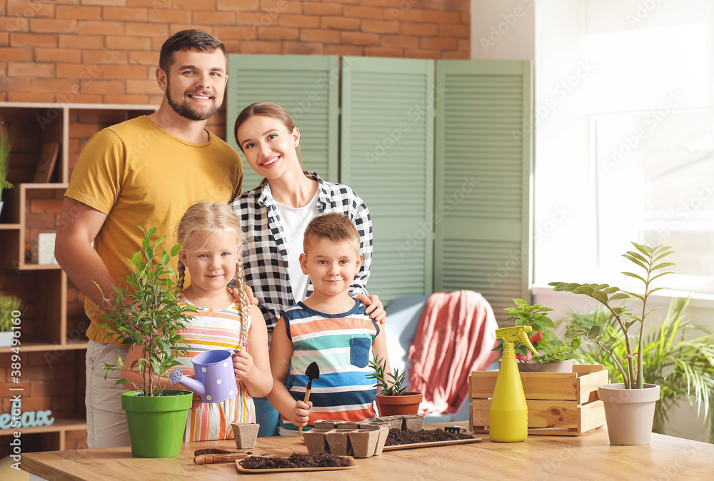 Young family setting out plants at home