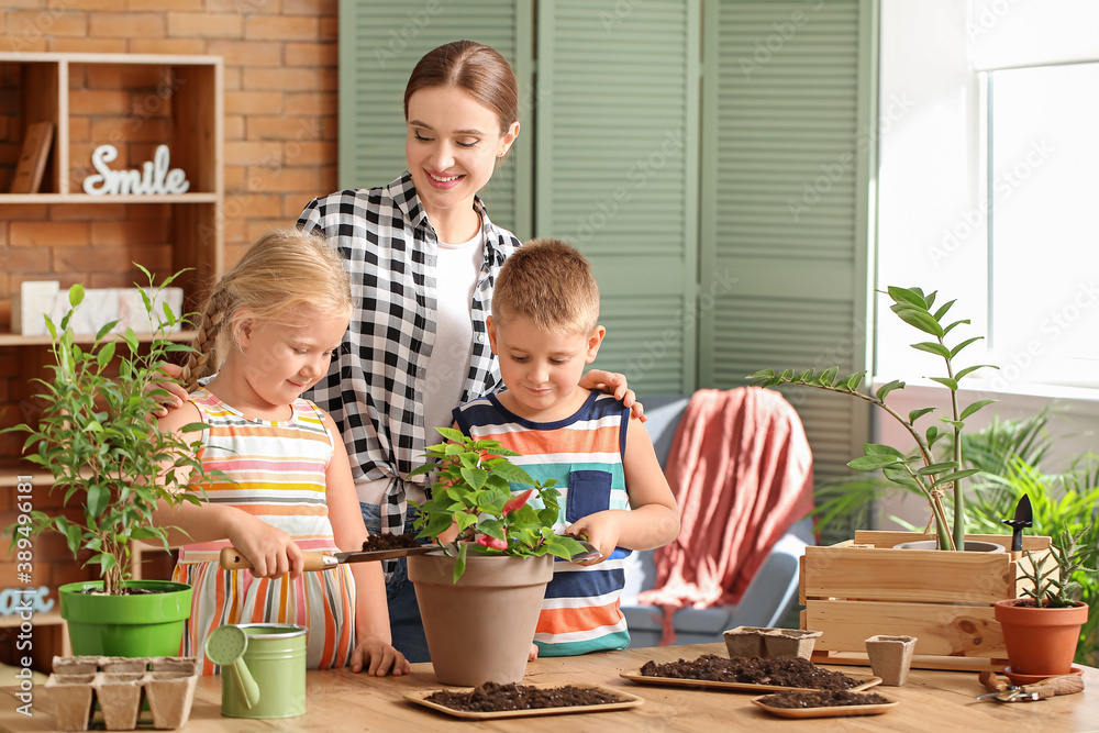 Young family setting out plants at home