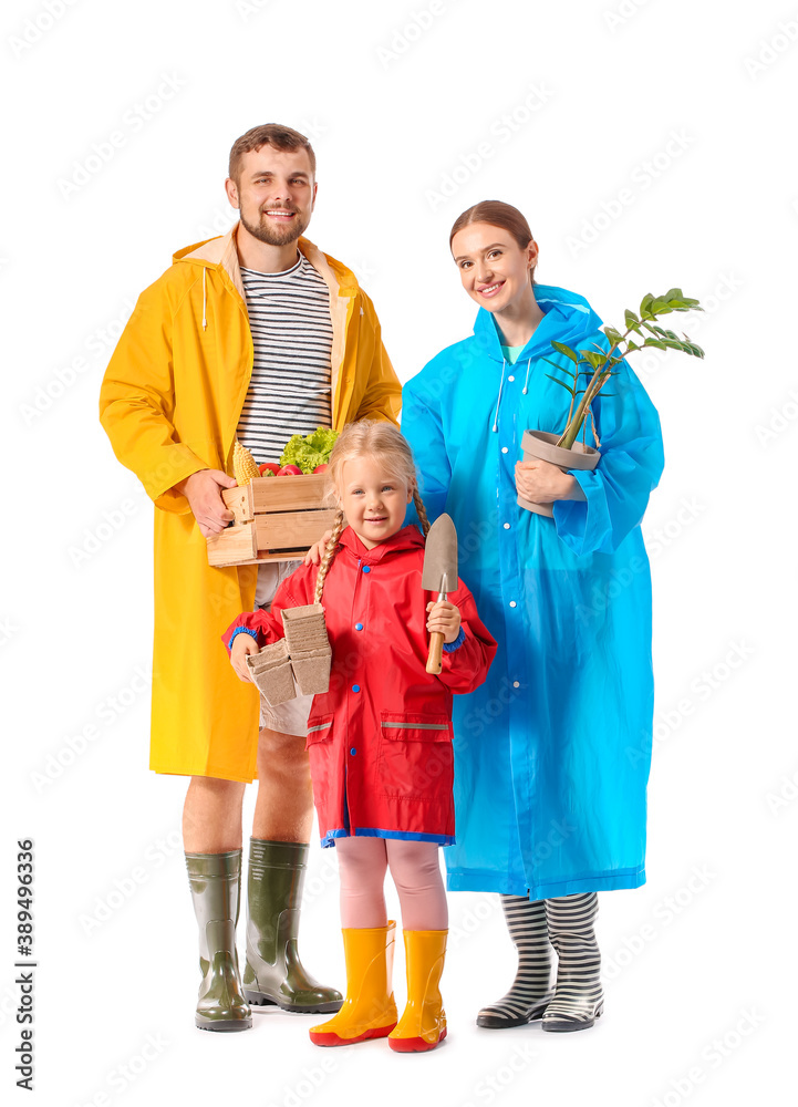 Young family with gardening supplies on white background