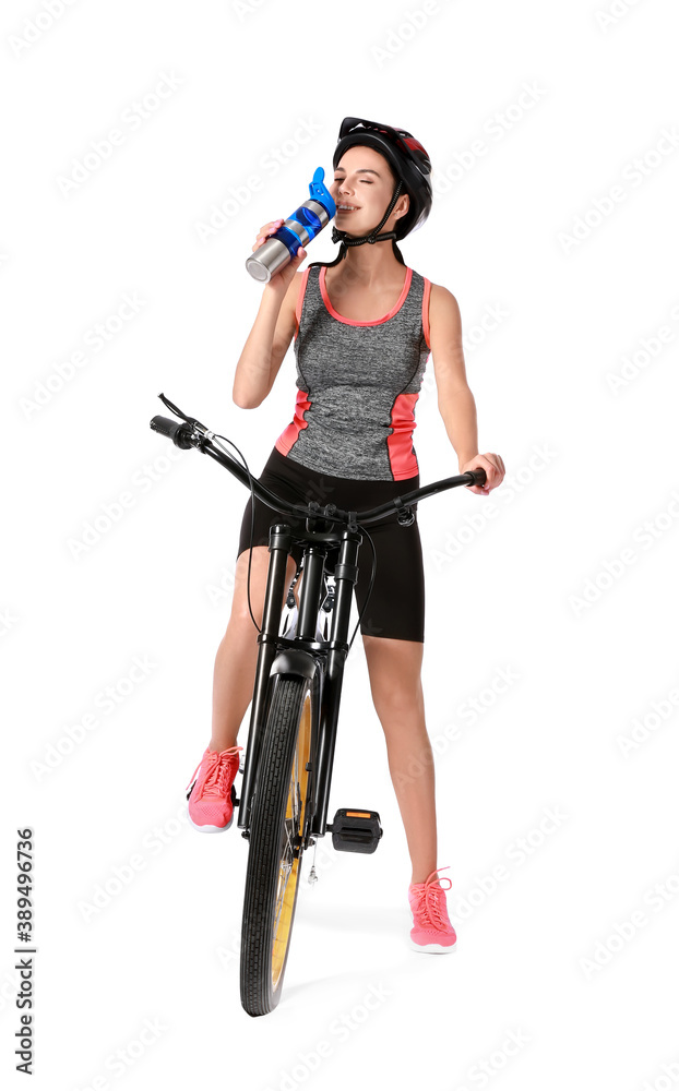 Female cyclist drinking water on white background