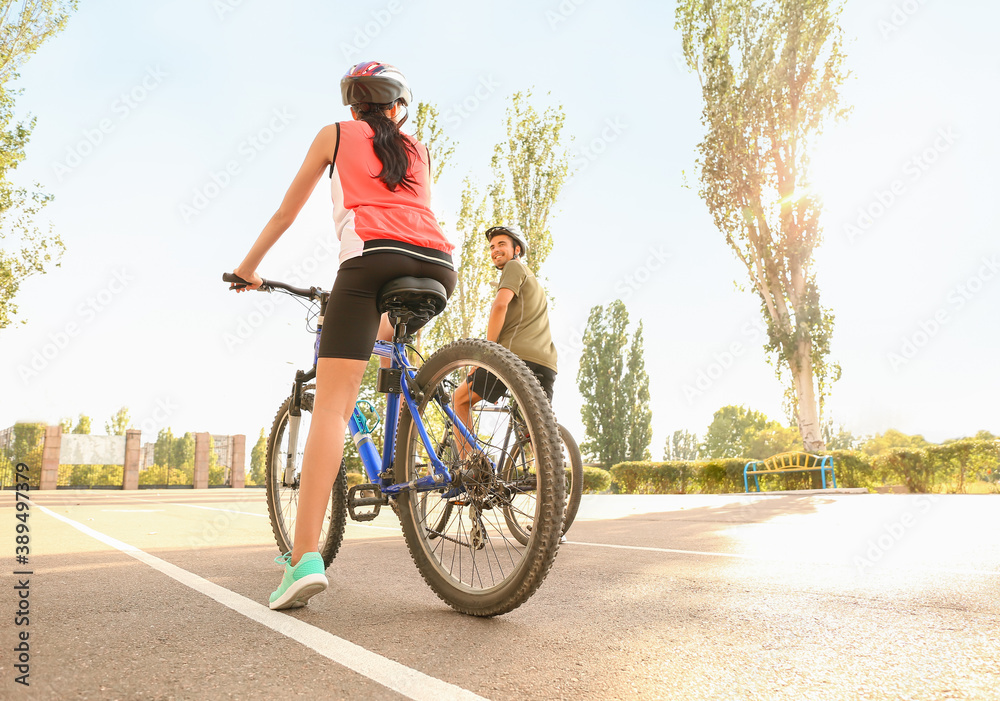 Sporty cyclists riding bicycles outdoors