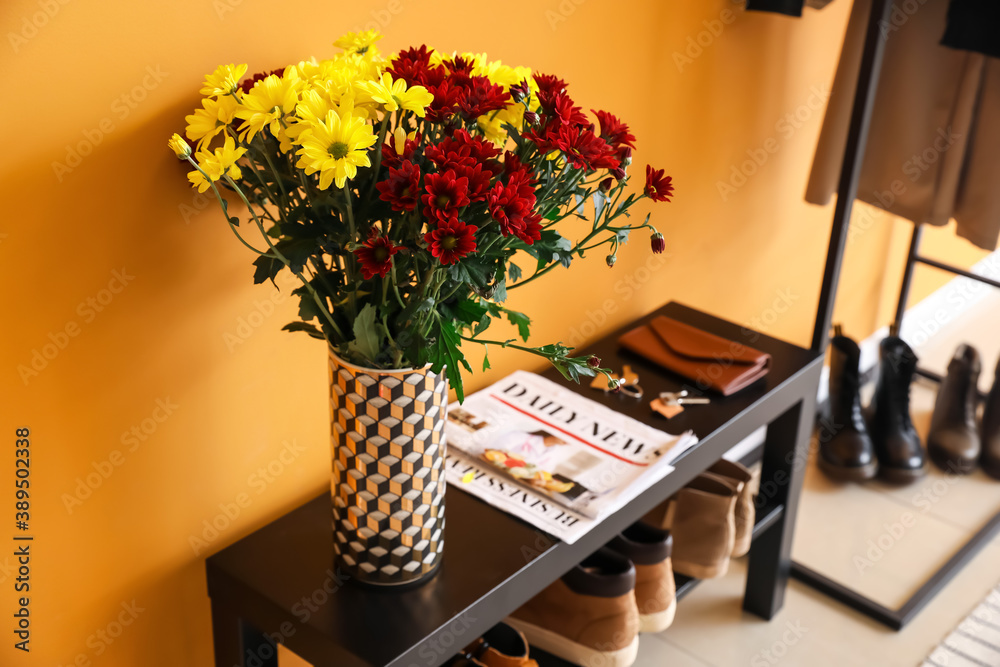 Stylish interior of modern hall with autumn flowers