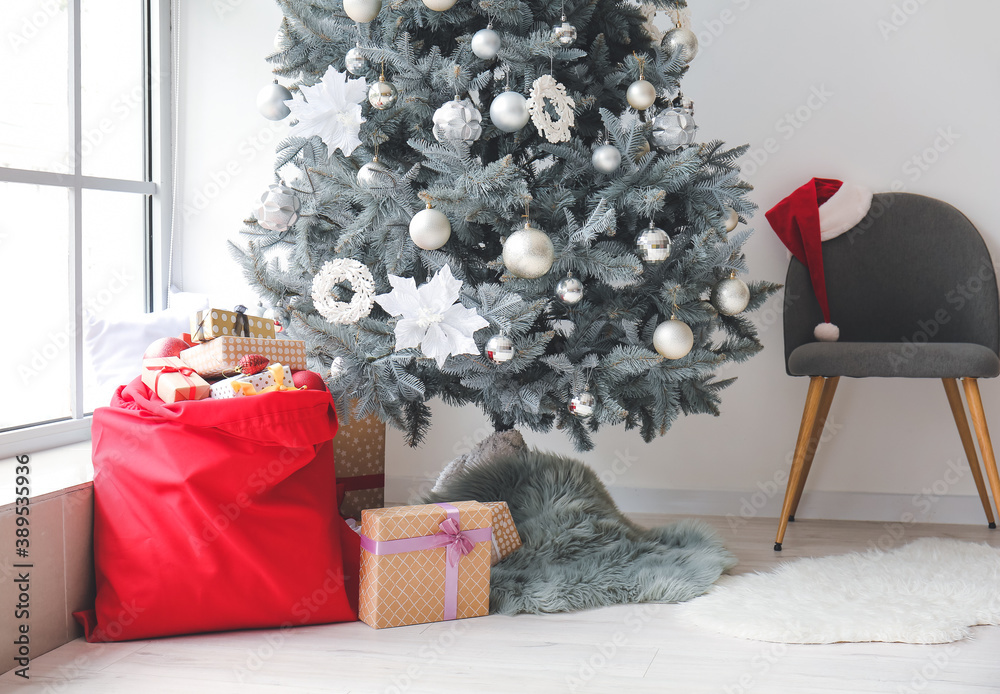 Interior of modern room with Christmas tree and Santa bag