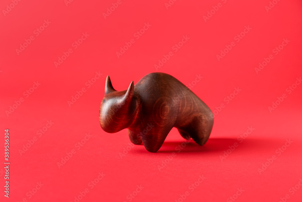 Figurine of bull as symbol of year 2021 on color background