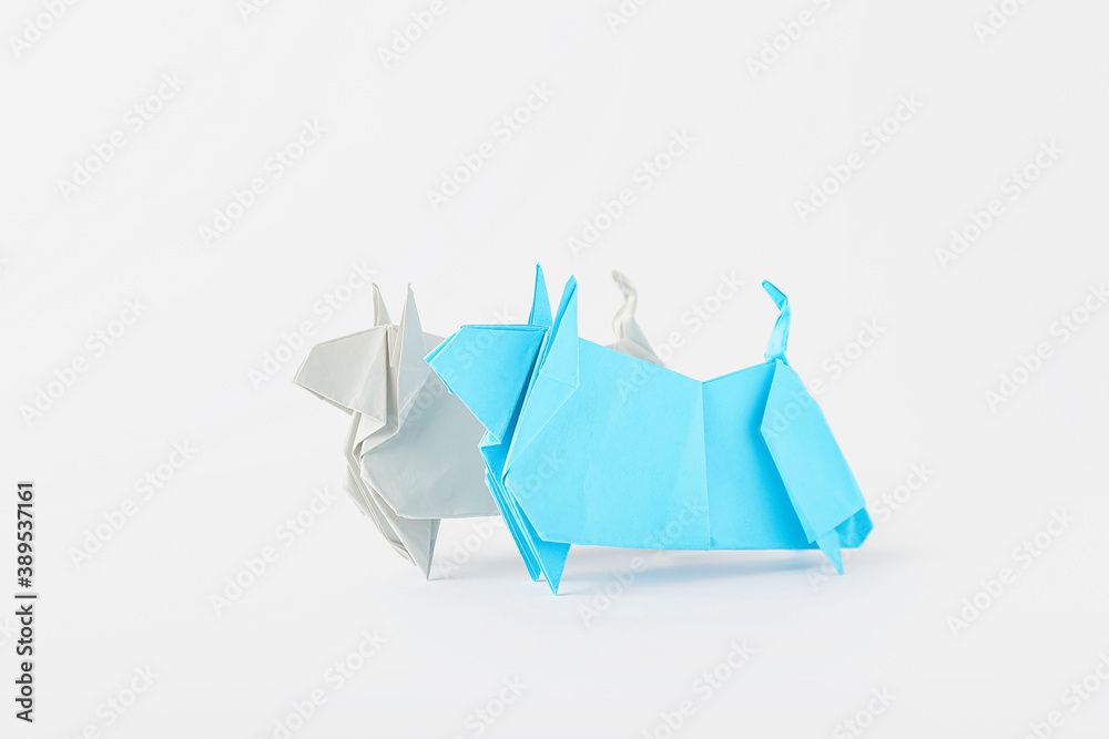 Origami bulls as symbol of year 2021 on white background