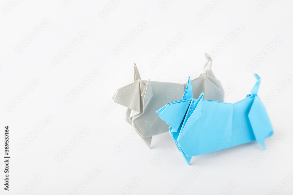 Origami bulls as symbol of year 2021 on white background