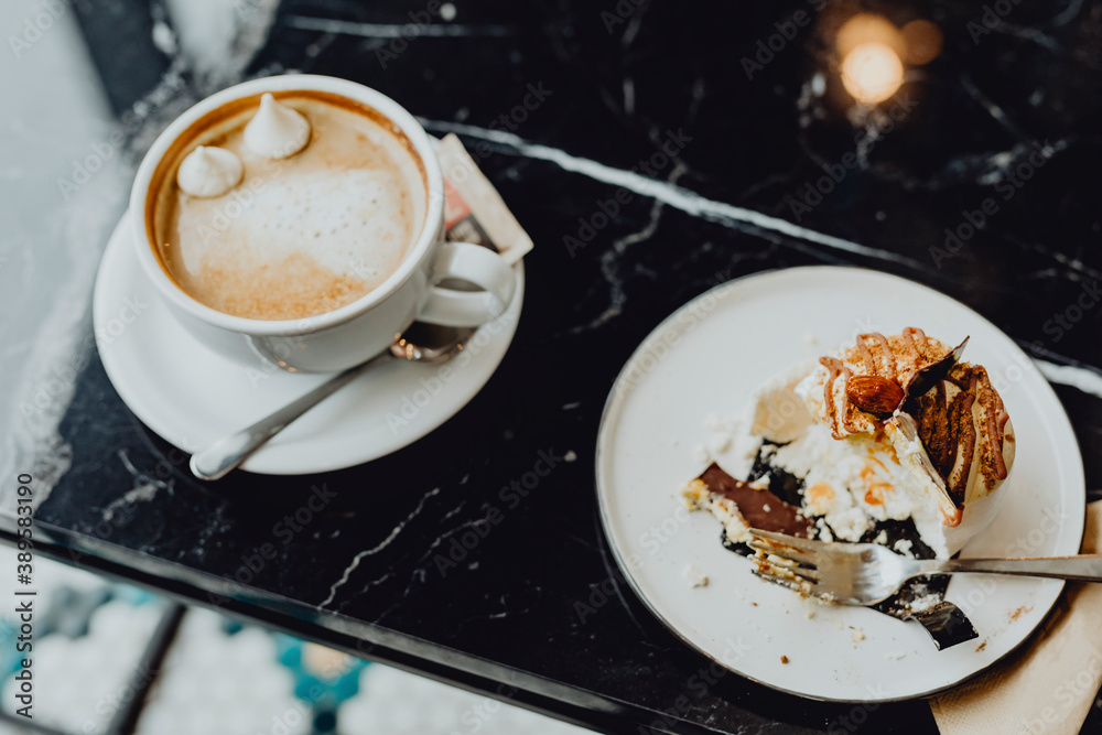 Cup of chocolate and a piece of meringue cake