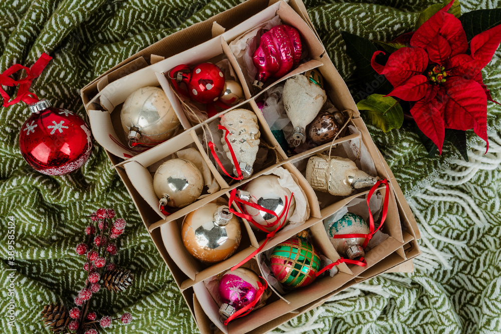 A box of Christmas ornaments on a green cloth