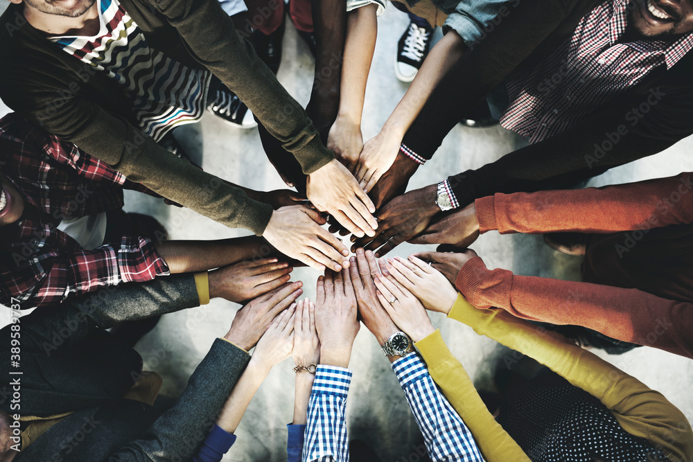 Aerial view of diverse people stacking hands in the middle