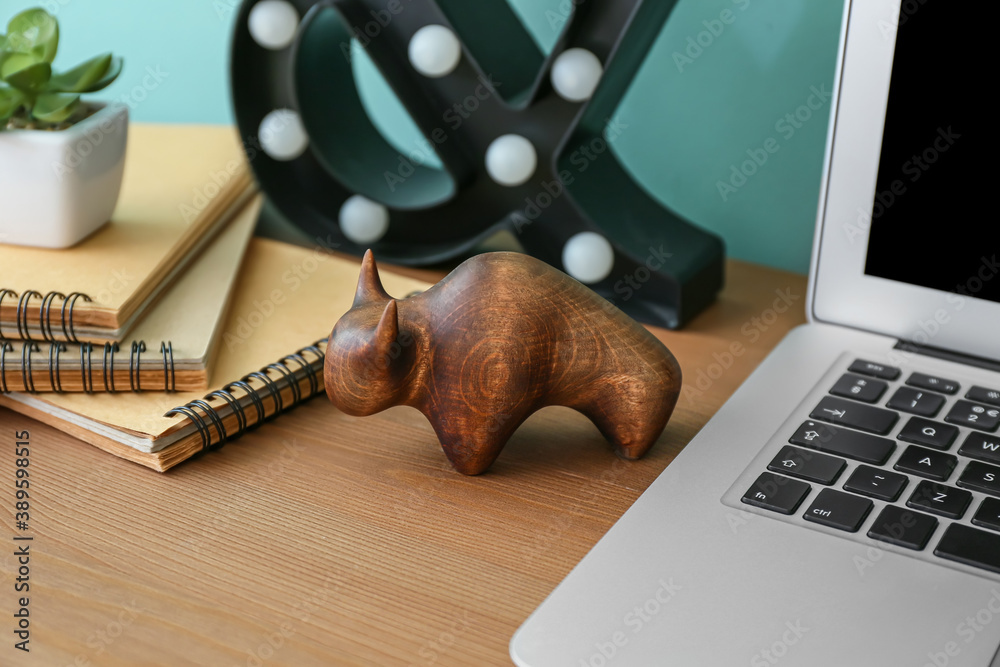 Figurine of bull as symbol of year 2021 on table in room