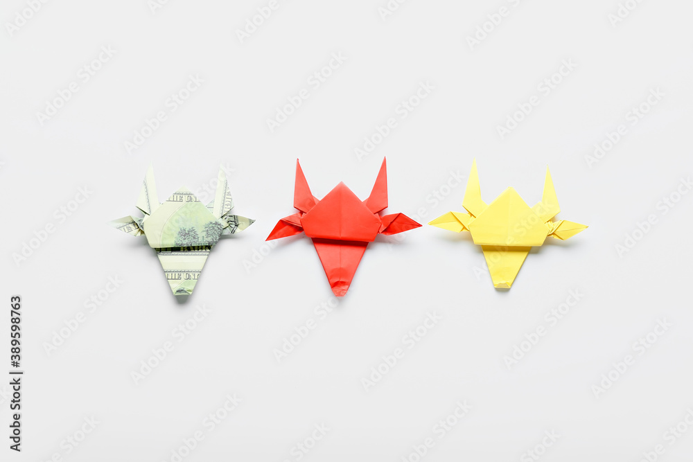 Origami bulls as symbol of year 2021 on white background