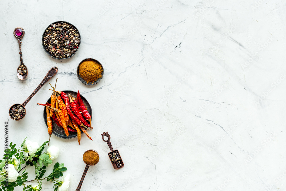 Hot spices and aromatic herbswith cooking utensils overhead