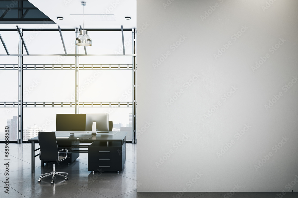 Clean office in loft style with computers and blank wall.