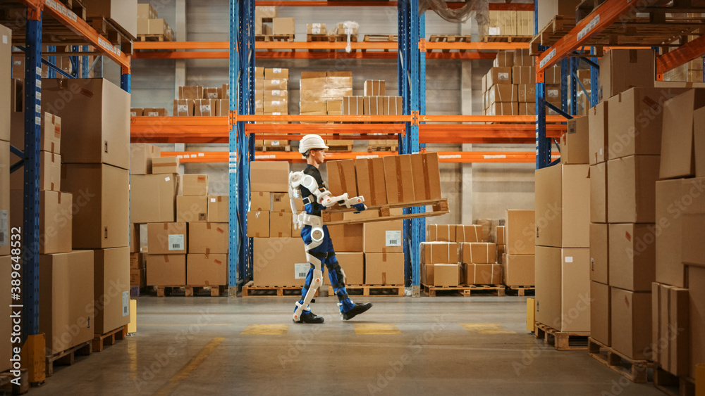 High-Tech Futuristic Warehouse: Manager Scans Packages for Inventory, Delivery in the Background Wor