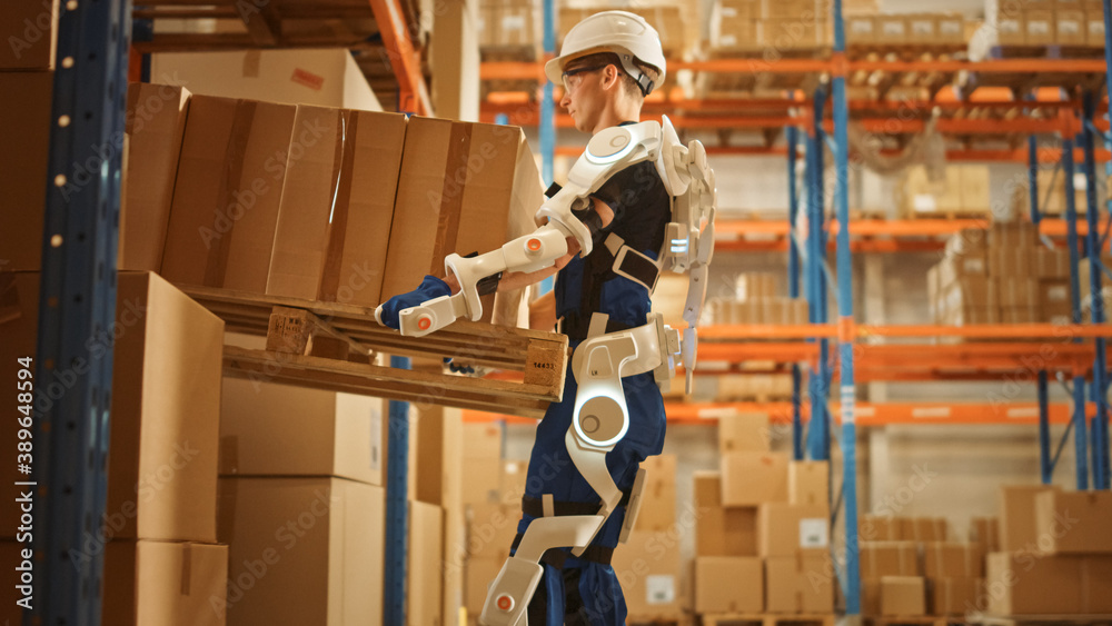 High-Tech Futuristic Warehouse: Worker Wearing Advanced Full Body Powered exoskeleton, Lifts Heavy P