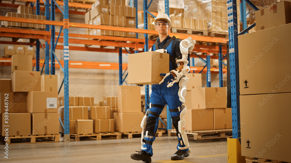 High-Tech Futuristic Warehouse: Worker Wearing Advanced Full Body Powered exoskeleton, Walks with He