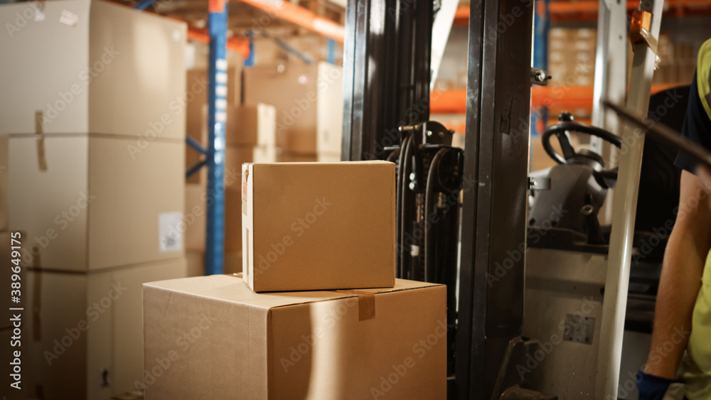 Big Retail Warehouse full of Shelves with Goods Stored on Manual Pallet Truck in Cardboard Boxes and