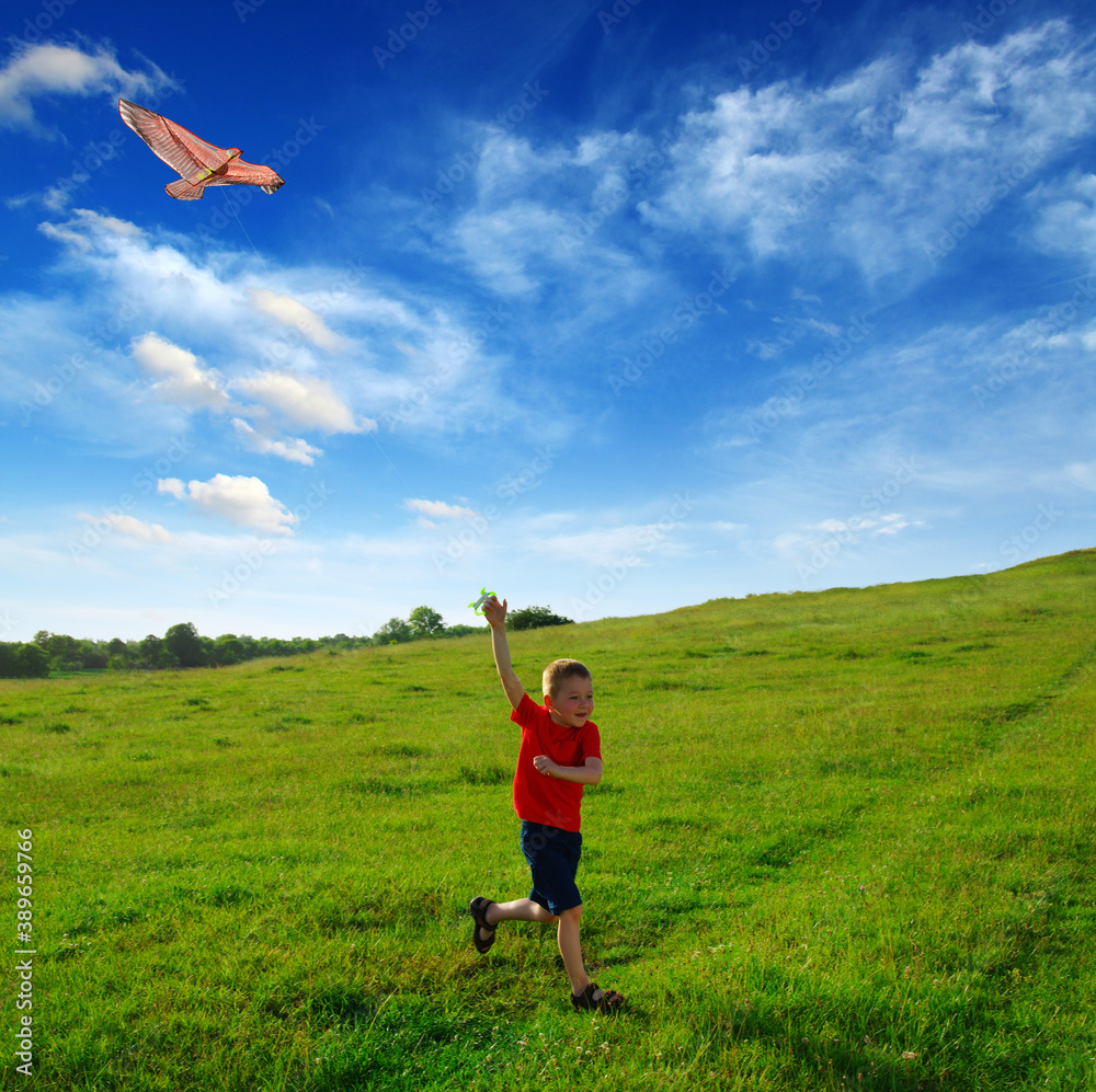 Little boy running with kite