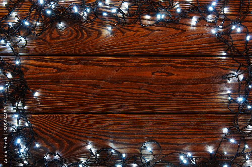 Сhristmas lights, background  ornaments on wood