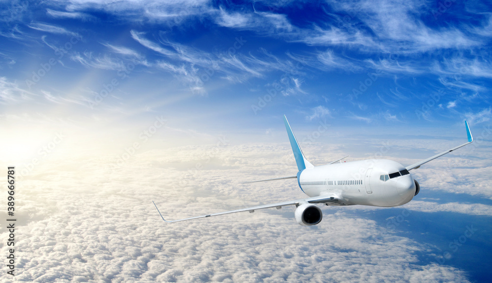 Landscape with airplane is flying in the blue sky and white clouds.