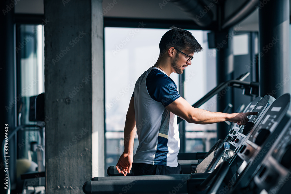 Young athlete training on a treadmill in the morning.