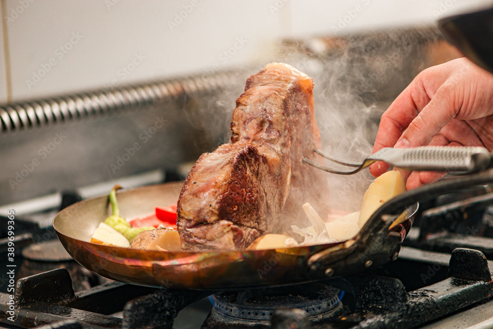 Professional t-bone steak preparation, close-up.