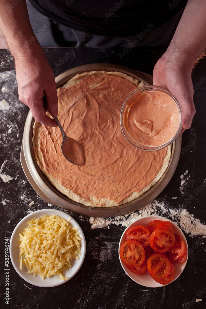 Making pizza at home. Fresh original Italian raw pizza, preparation in traditional style.