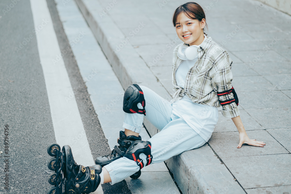 A photo of a girl rollerblading in the street
