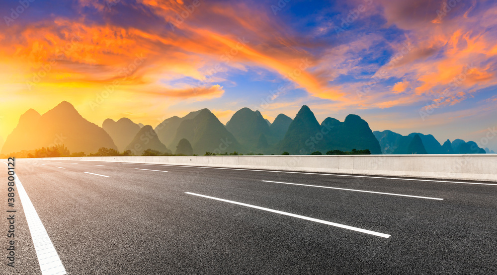 Country asphalt road and green mountain natural scenery in Guilin at sunrise,China.