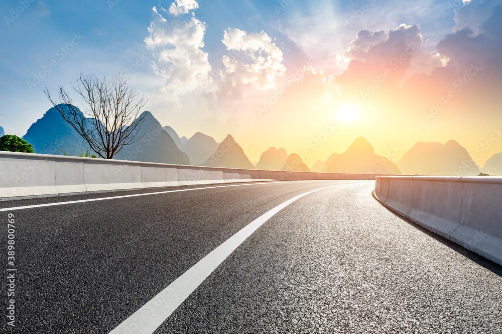 Country asphalt road and green mountain natural scenery in Guilin at sunrise,China.