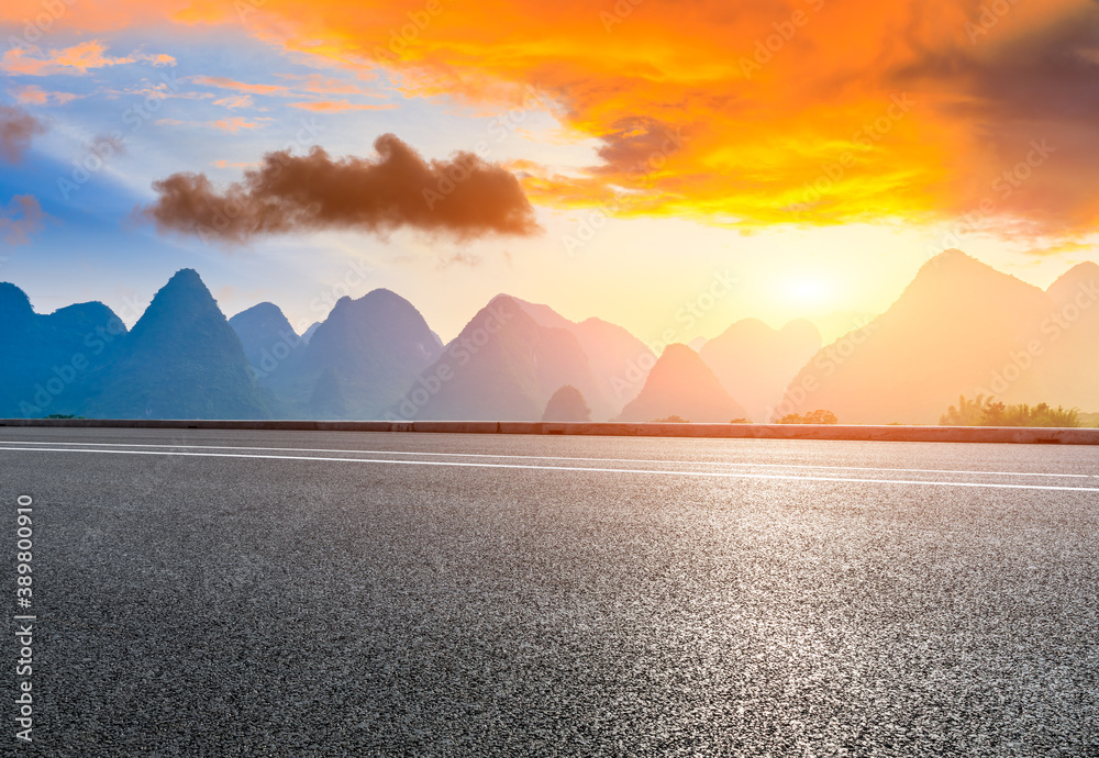 Country asphalt road and green mountain natural scenery in Guilin at sunrise,China.