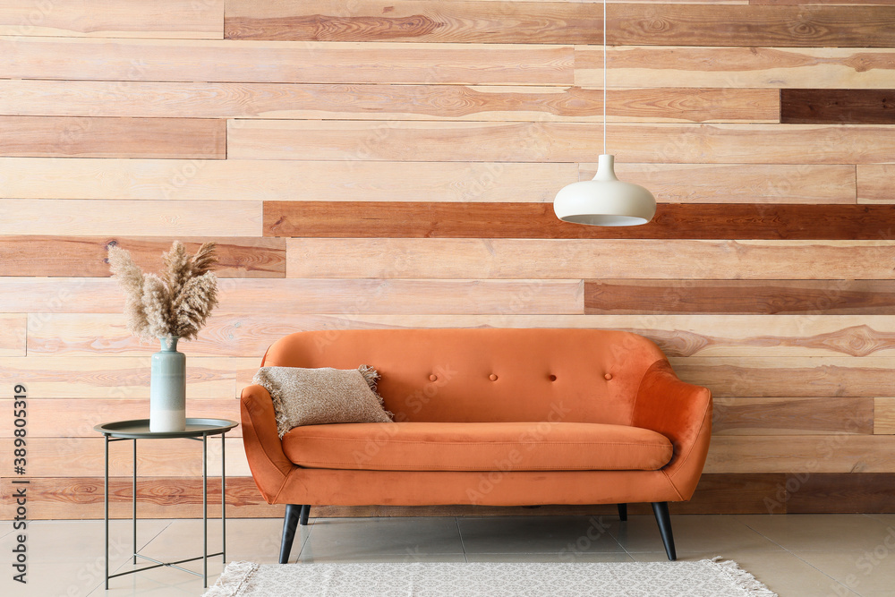 Sofa and table near wooden wall