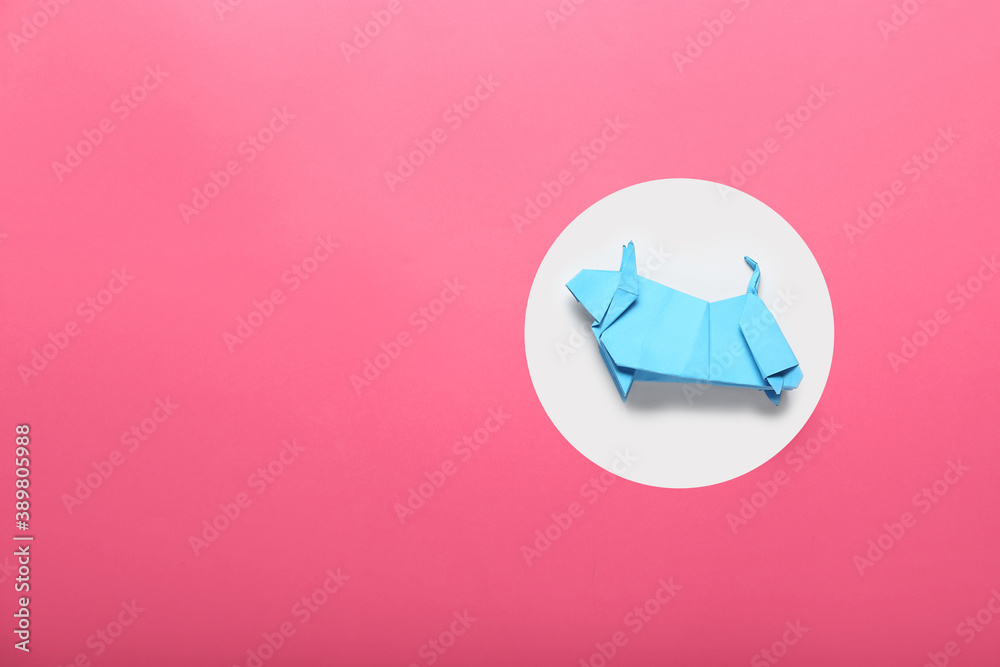 Origami bull as symbol of year 2021 on color background