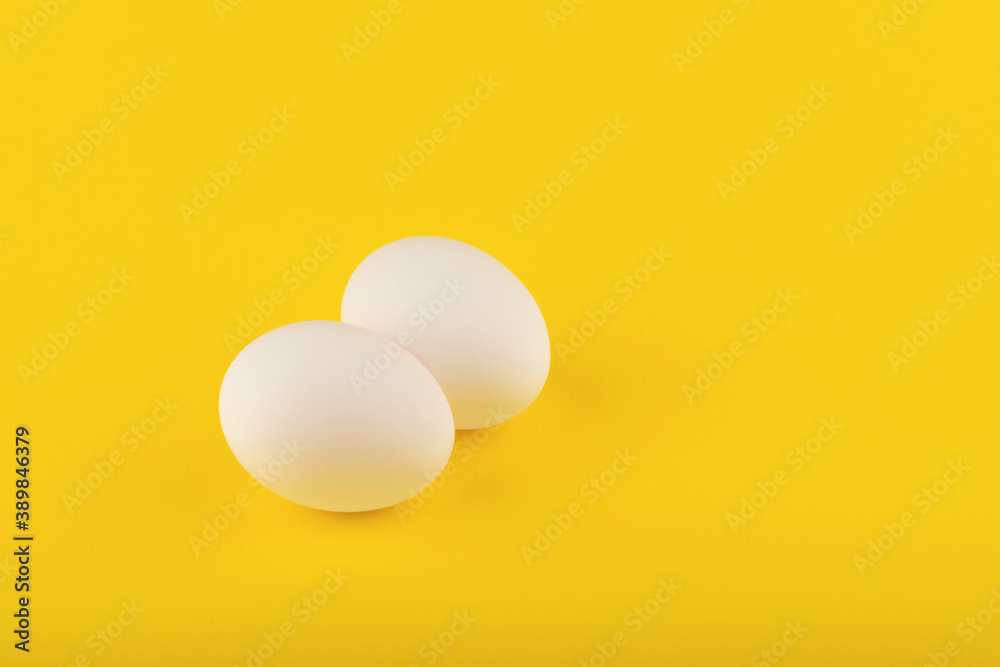 chicken eggs on yellow background