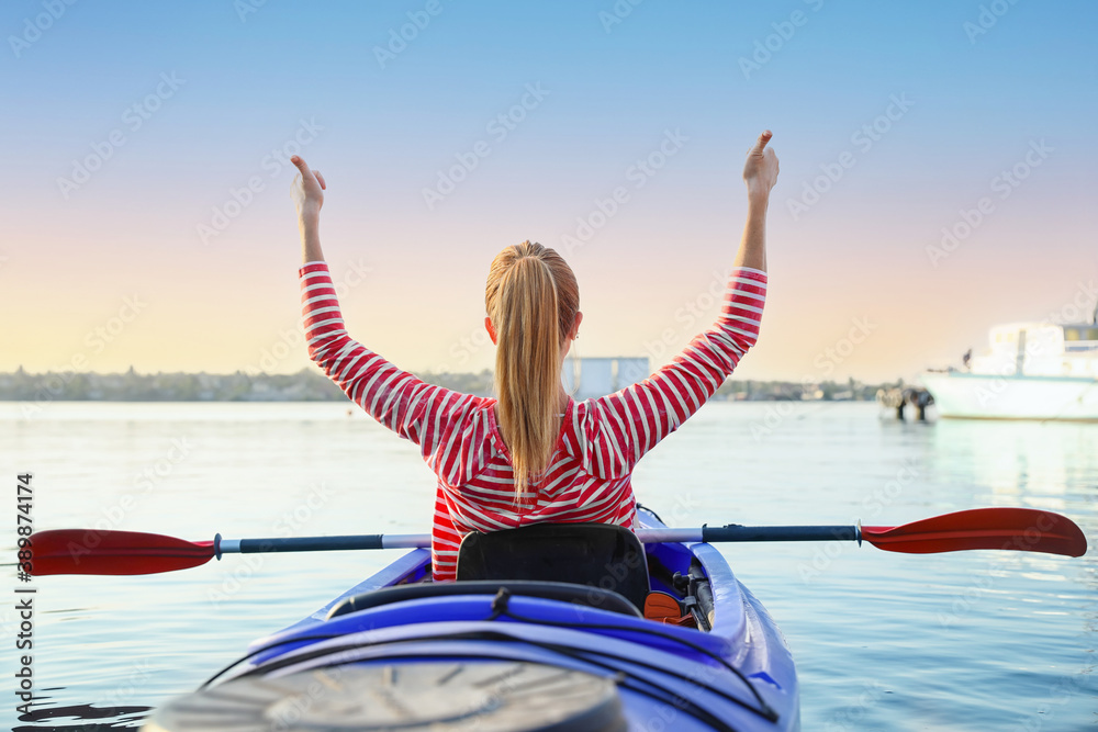 Young woman kayaking in river