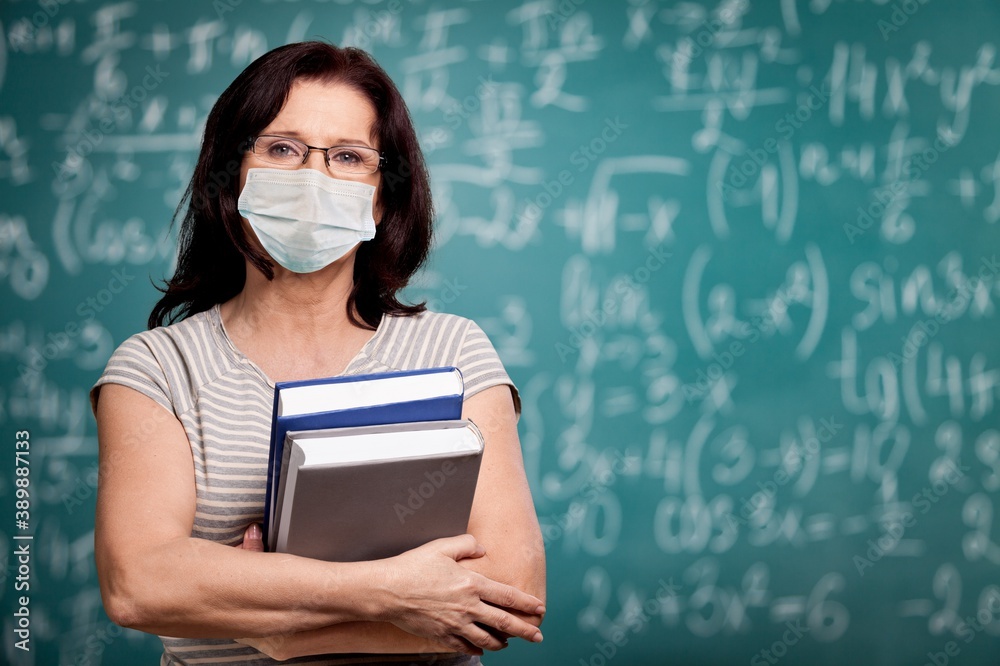 Smile woman teacher with books on background